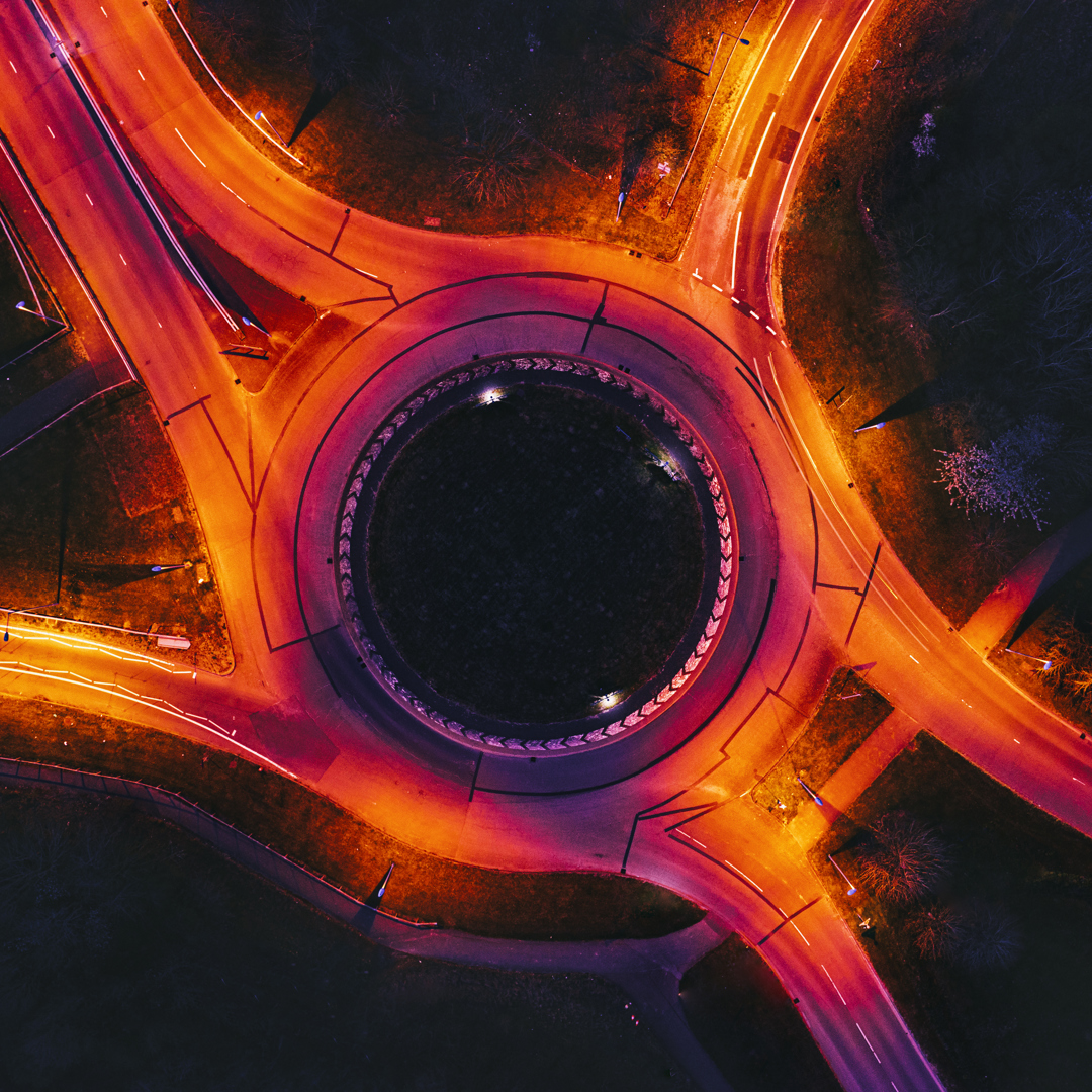 Arial view of motorway roundabout lit up in orange lights
